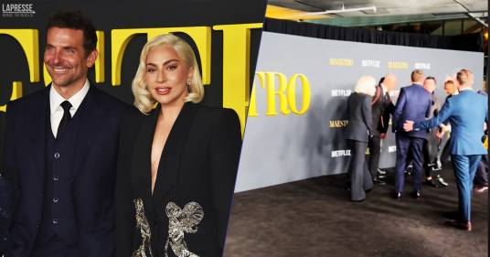 Il fotografo cade di schiena sul red carpet: Lady Gaga e Bradley Cooper non esitano nell’aiutarlo